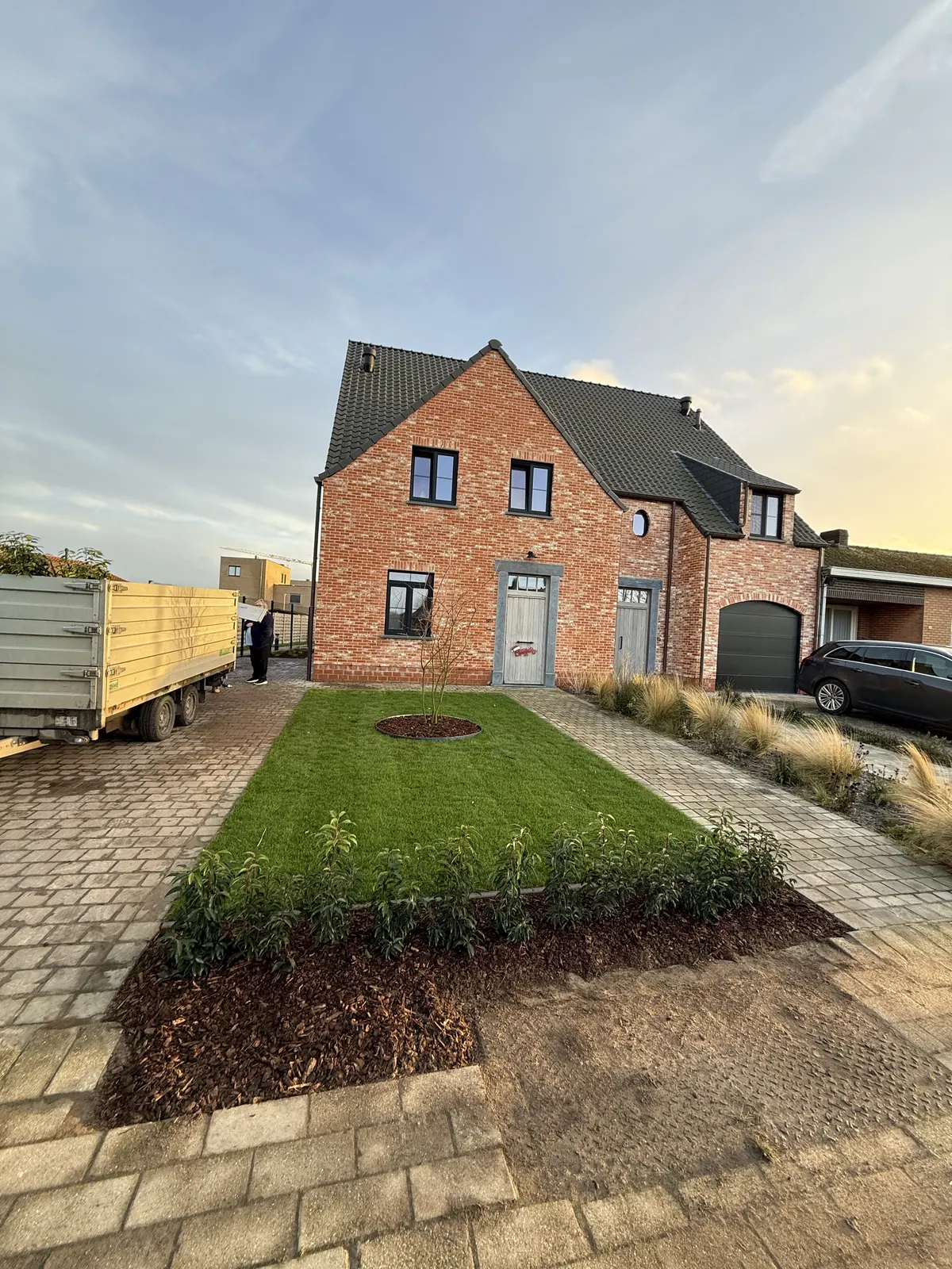 Voortuin met oprit in klinkers, nieuw gazon en beplanting